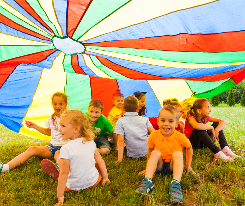 Happy children playing with a parachute