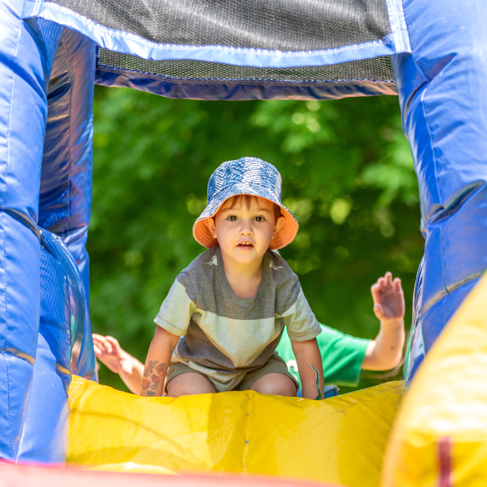 A child on top of an inflatable slide