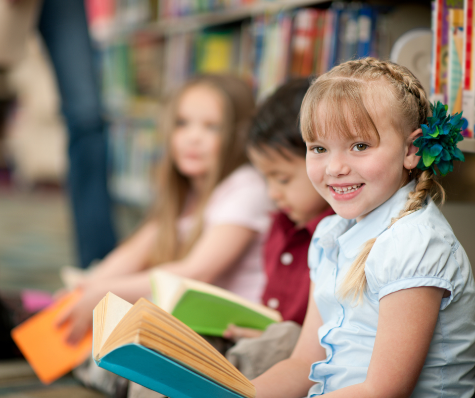 Children reading a book.