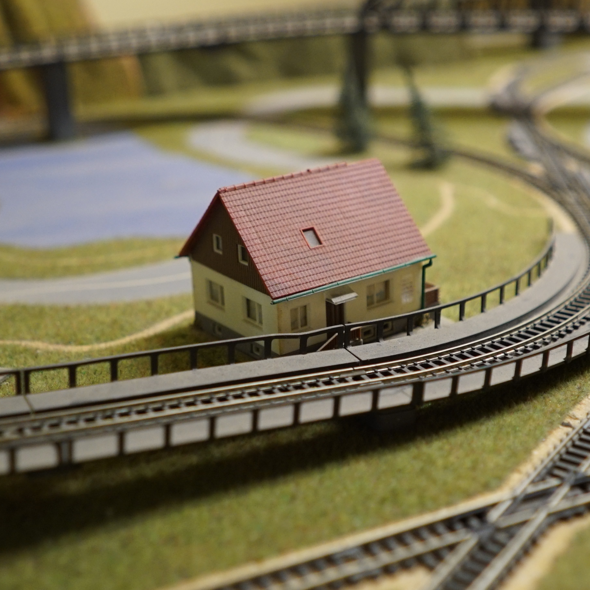 A model train station with a track and a building