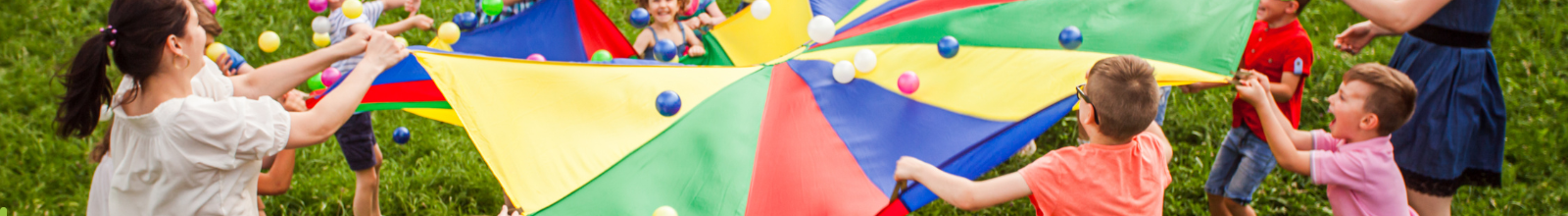Kids playing with a parachute at a park