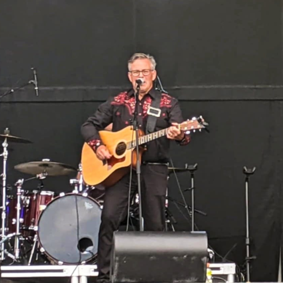 Terry on stage with a guitar