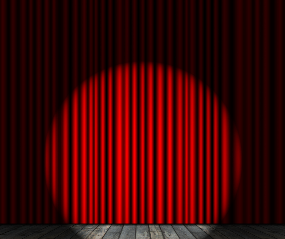 A red curtain on a stage with a spotlight on it