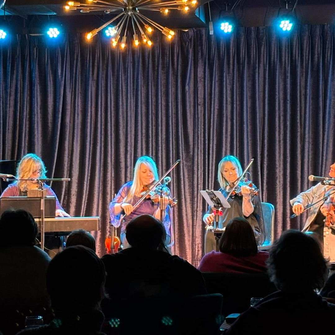 The Women of Fiddle in performance on stage