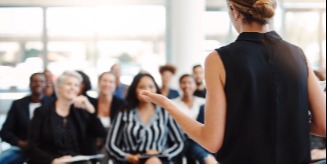 Someone providing a lecture to attendees