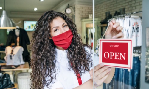 Business owner opening business with mask on