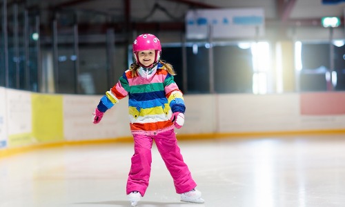 Parent teaching child to skate