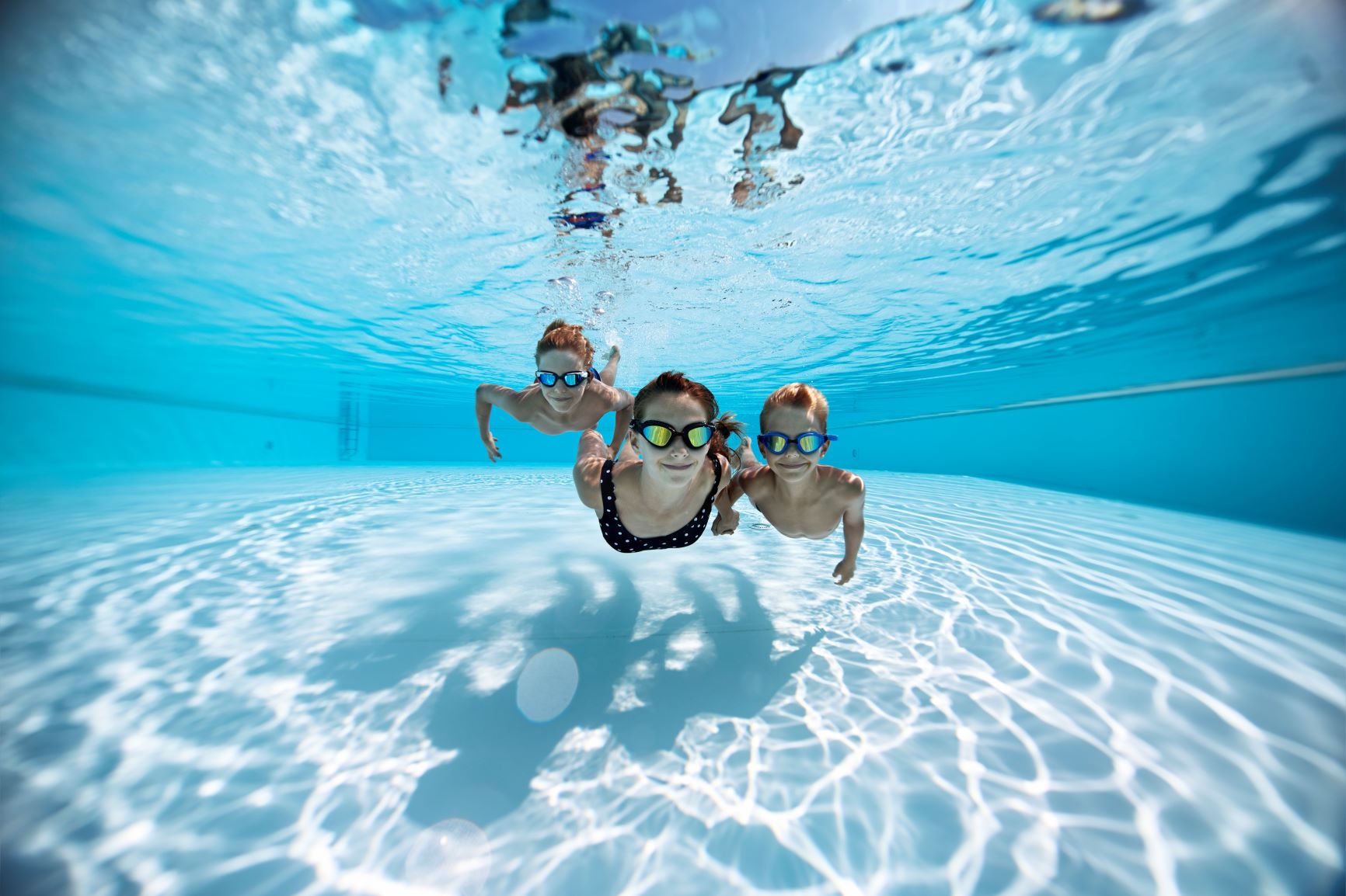 Family swimming under water