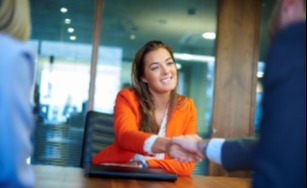 Women shaking hands at an interview