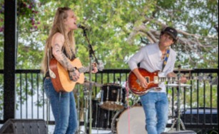 A duo singing and playing guitar