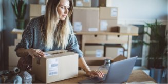 A woman prepares a label to ship a product