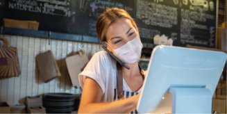 A woman uses a computer at a business