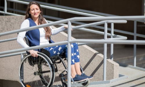 Lady in a wheelchair using a ramp