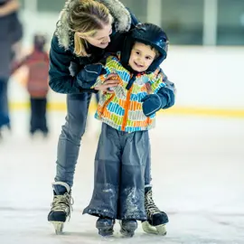 Child and parent skating together 
