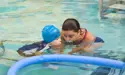 Little boy enjoying swimming lessons 