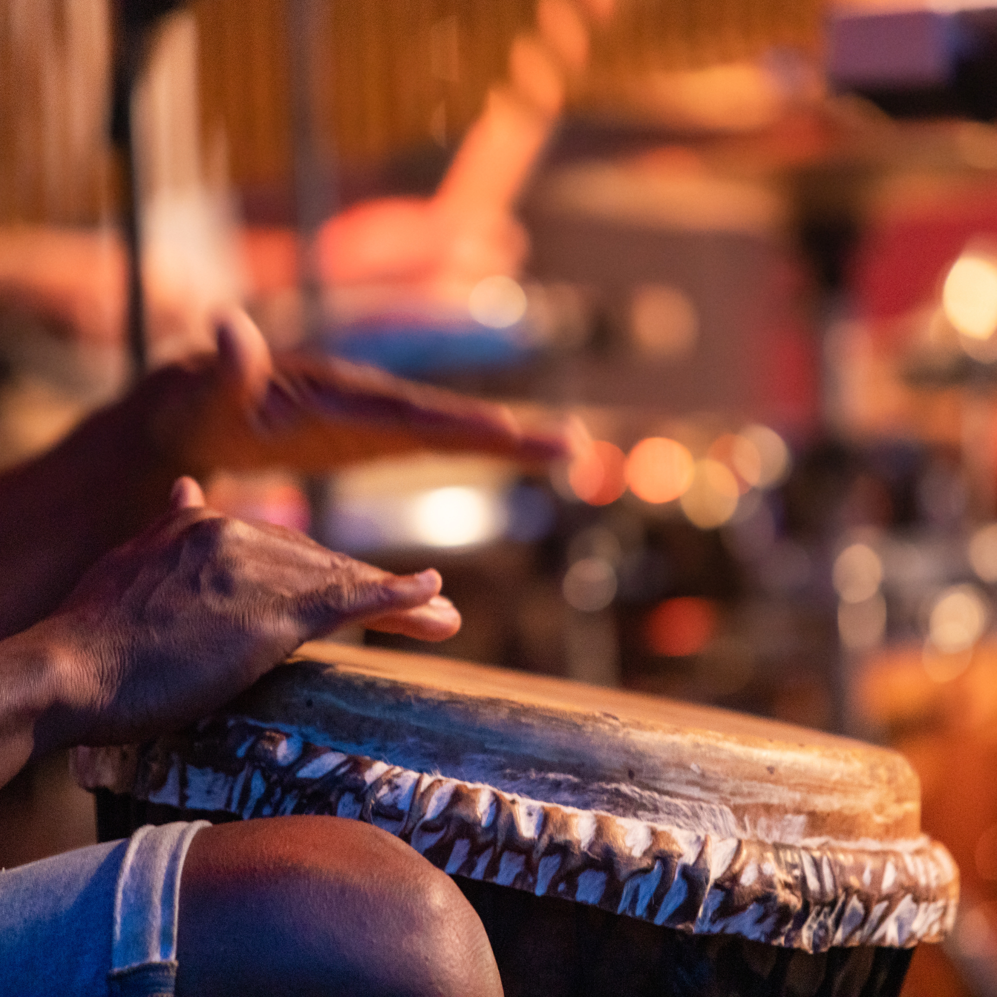 A person holding a drum about to hit it